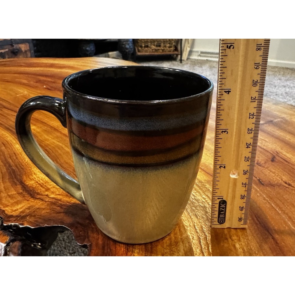 This item is the discontinued "Cosmos" pattern stoneware mug produced by Mikasa